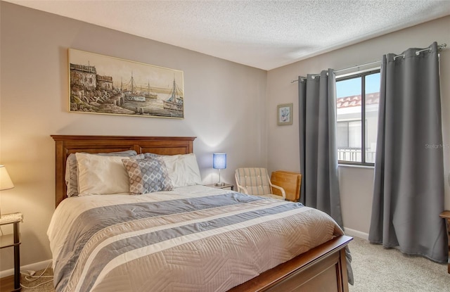 bedroom with carpet floors and a textured ceiling