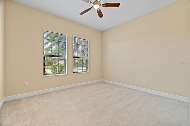 spare room featuring ceiling fan and light carpet