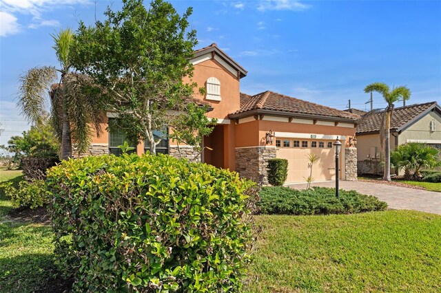 view of front facade with a garage and a front lawn