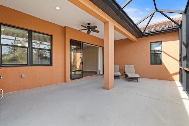 view of patio / terrace with ceiling fan and glass enclosure