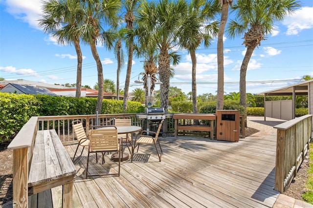 wooden terrace featuring area for grilling