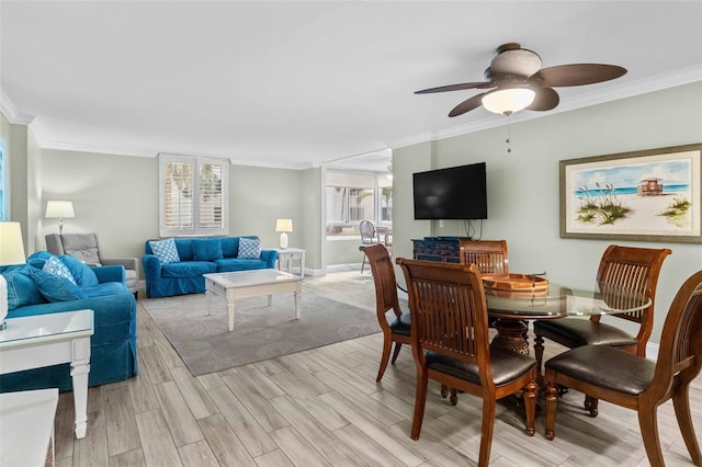 dining area with crown molding, ceiling fan, and light wood-type flooring