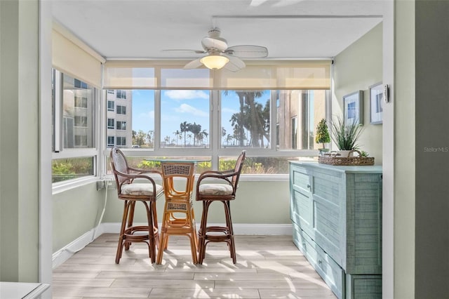 sunroom with ceiling fan