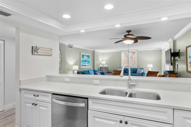 kitchen featuring white cabinetry, sink, stainless steel dishwasher, crown molding, and light wood-type flooring