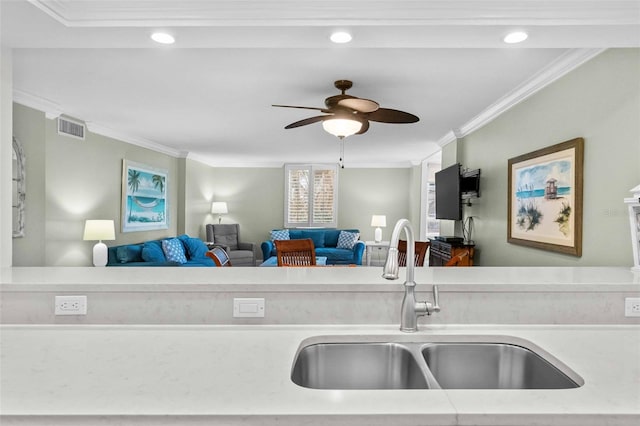 kitchen featuring crown molding, ceiling fan, and sink