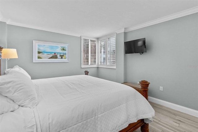 bedroom featuring ornamental molding and light hardwood / wood-style floors