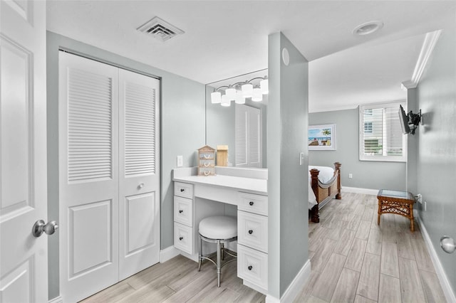 bathroom with vanity and crown molding