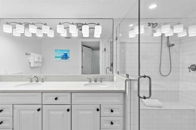 bathroom featuring an enclosed shower and vanity