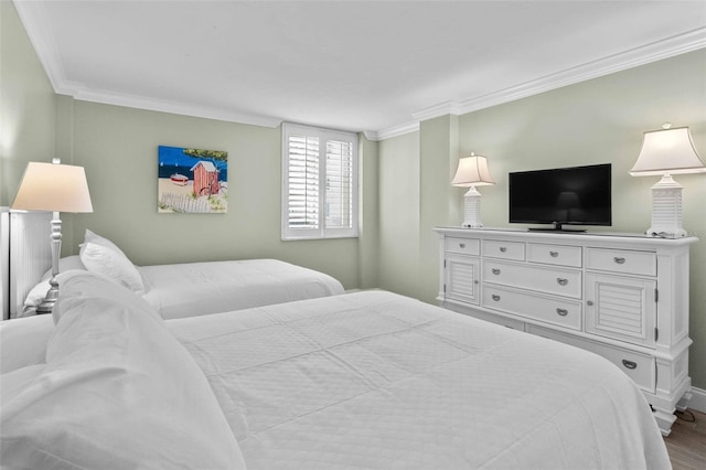 bedroom featuring crown molding and light hardwood / wood-style floors