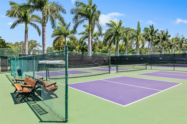 view of tennis court with basketball hoop