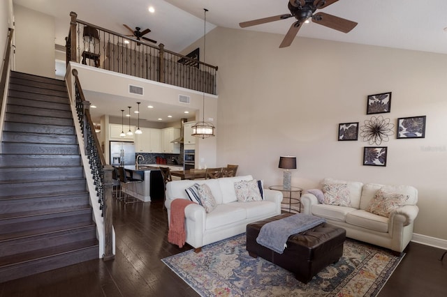 living room with dark hardwood / wood-style flooring, high vaulted ceiling, sink, and ceiling fan