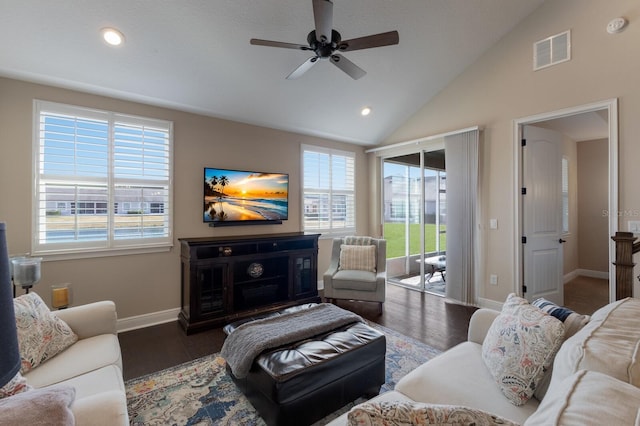 living room with lofted ceiling, plenty of natural light, dark wood-type flooring, and ceiling fan