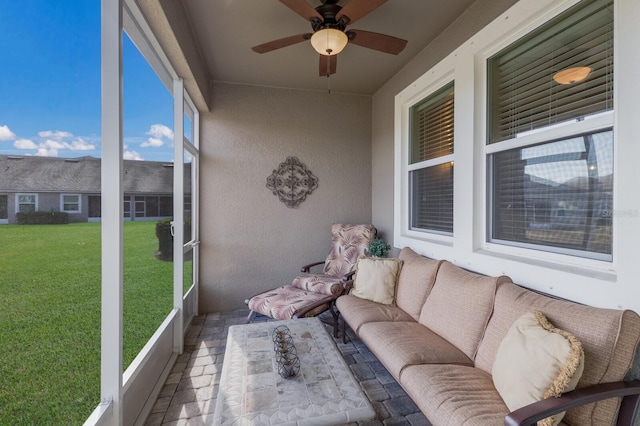 unfurnished sunroom with ceiling fan