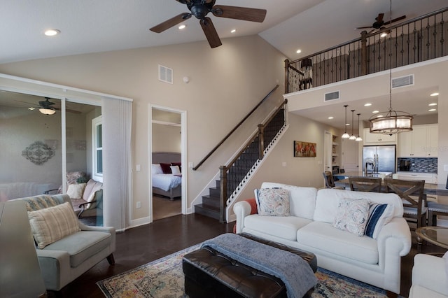 living room with high vaulted ceiling, dark hardwood / wood-style floors, and ceiling fan