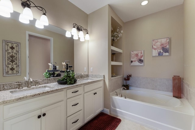 bathroom with tile patterned flooring, vanity, built in features, and a tub to relax in