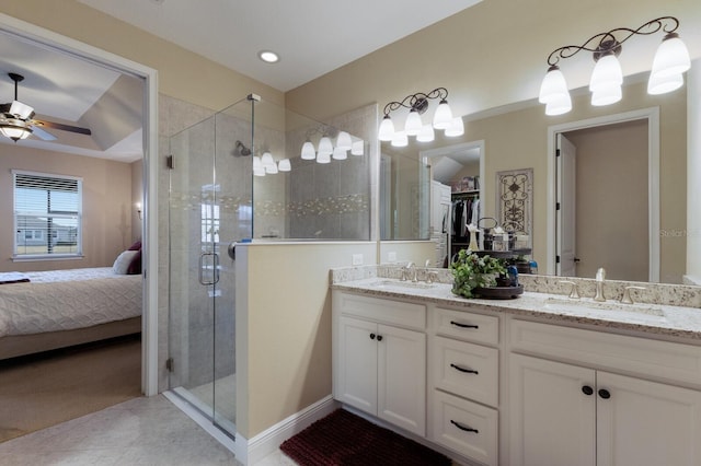 bathroom featuring ceiling fan, vanity, a shower with shower door, and tile patterned floors