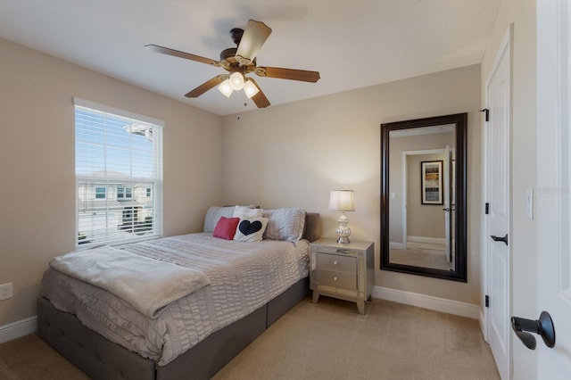 bedroom with ceiling fan and light colored carpet