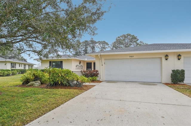 single story home with a garage and a front lawn