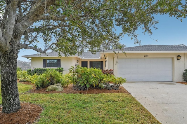 ranch-style home featuring a garage and a front yard