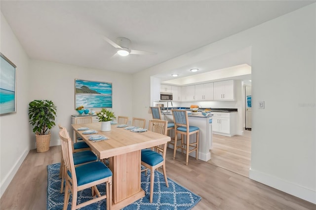 dining room featuring ceiling fan and light hardwood / wood-style flooring