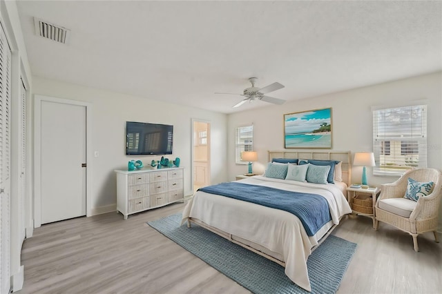 bedroom featuring multiple windows, ceiling fan, and light hardwood / wood-style floors