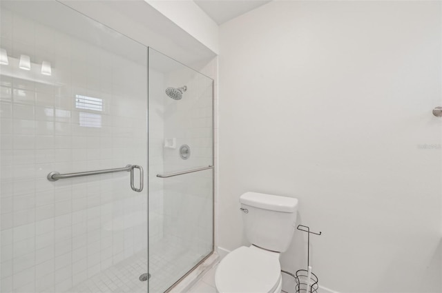 bathroom featuring an enclosed shower and toilet