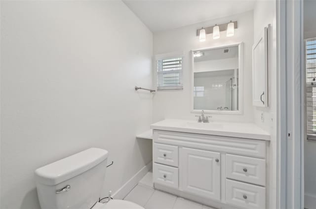 bathroom with vanity, toilet, tile patterned flooring, and a shower