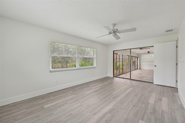 unfurnished bedroom featuring ceiling fan, access to exterior, light hardwood / wood-style floors, and a textured ceiling