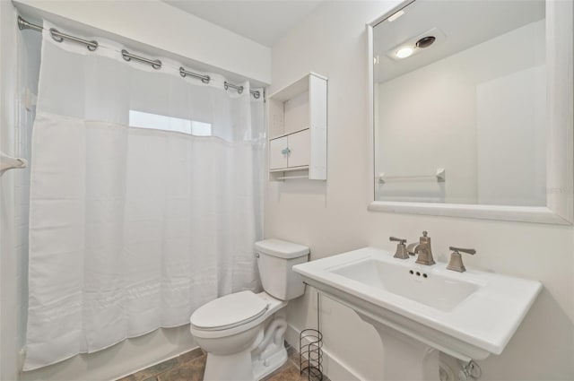 full bathroom with shower / bath combination with curtain, toilet, and sink