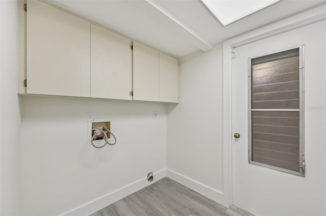 laundry area with washer hookup, hookup for an electric dryer, cabinets, and light wood-type flooring