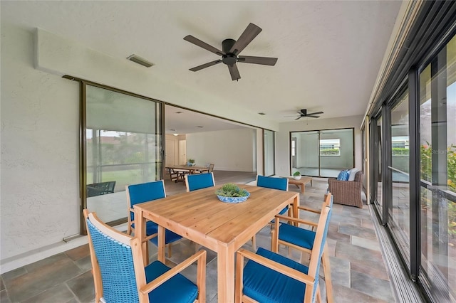 sunroom with ceiling fan