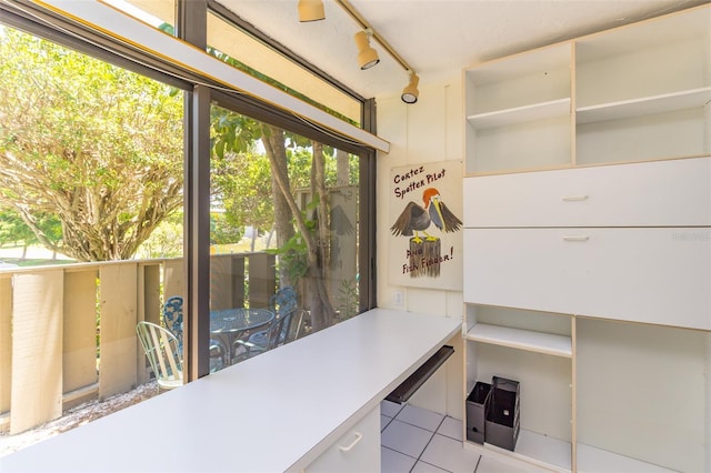 tiled home office featuring rail lighting