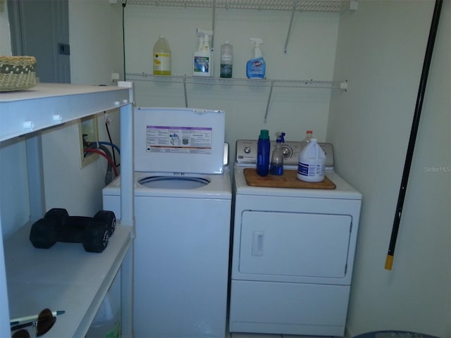 laundry room featuring washer and clothes dryer and electric panel