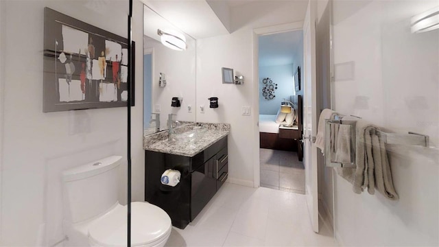 bathroom with tile patterned floors, vanity, and toilet