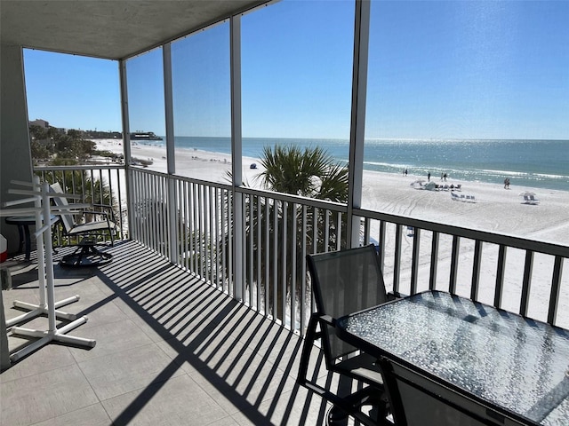 balcony with a view of the beach and a water view