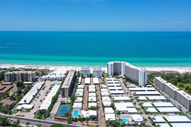 drone / aerial view featuring a water view and a beach view