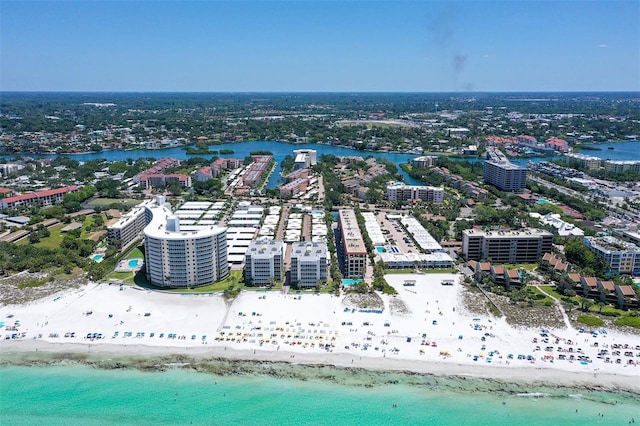 drone / aerial view featuring a water view and a view of the beach