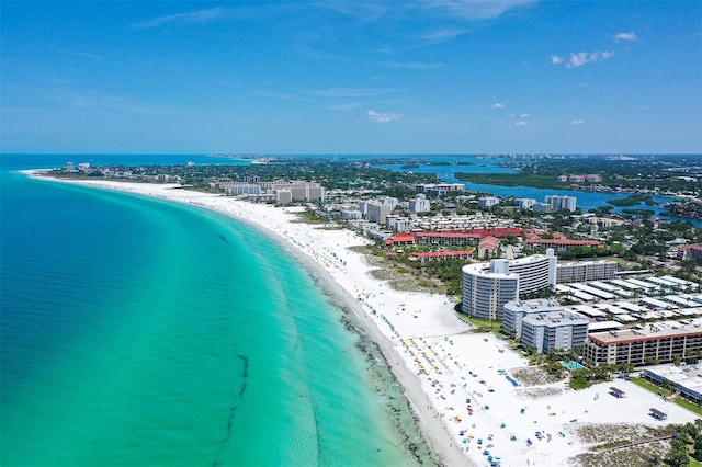 drone / aerial view with a water view and a beach view