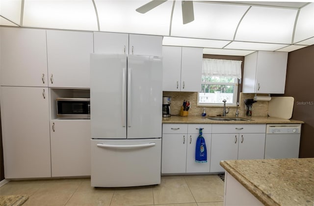 kitchen with sink, white cabinets, and white appliances