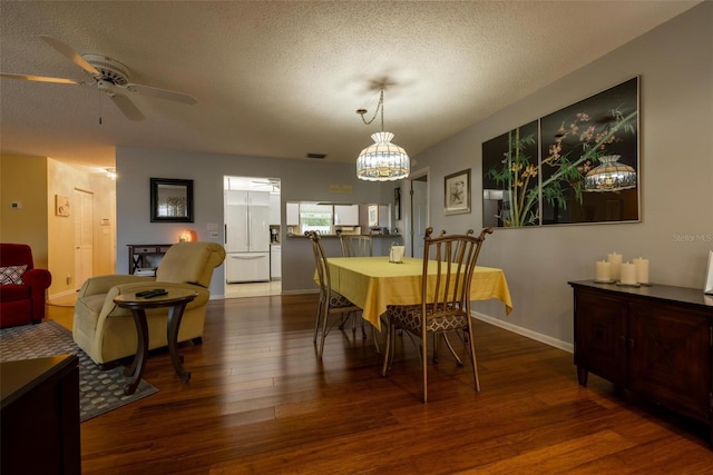 dining area with ceiling fan, dark hardwood / wood-style floors, and a textured ceiling