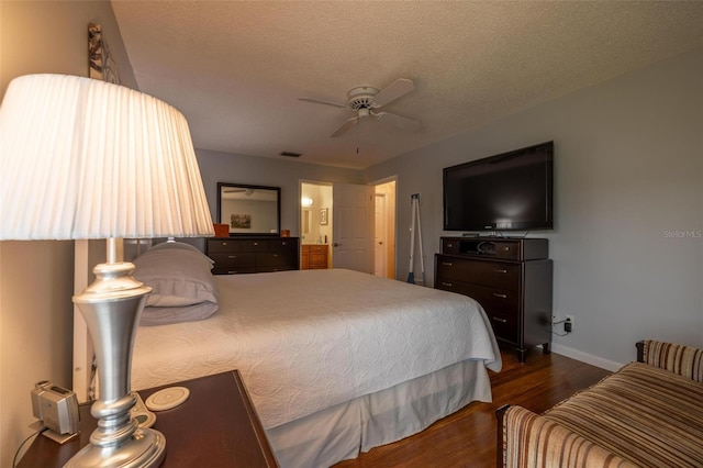 bedroom with ceiling fan, dark wood-type flooring, and a textured ceiling