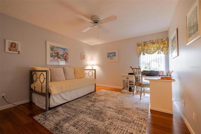 bedroom with a textured ceiling and dark hardwood / wood-style flooring