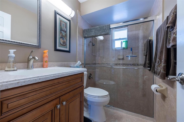 bathroom with vanity, tile patterned flooring, a shower with shower door, and toilet