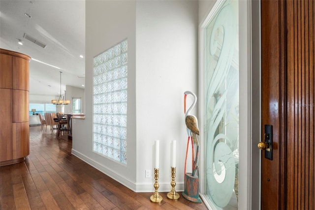 foyer featuring dark hardwood / wood-style floors and a chandelier