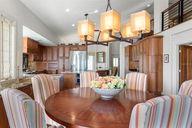 dining room featuring a towering ceiling