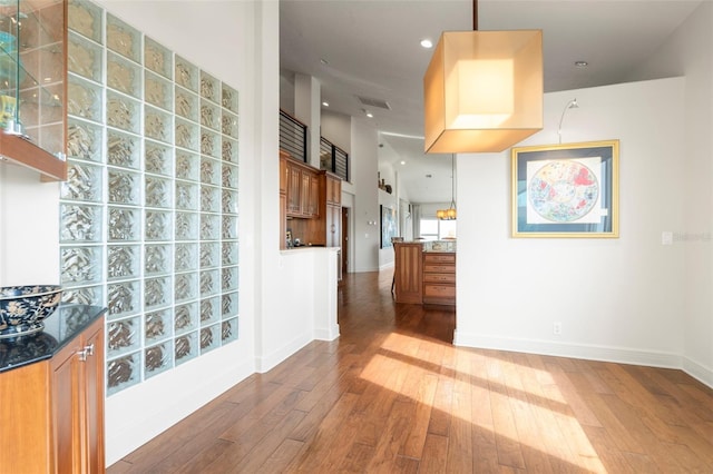 kitchen with hardwood / wood-style floors and decorative light fixtures