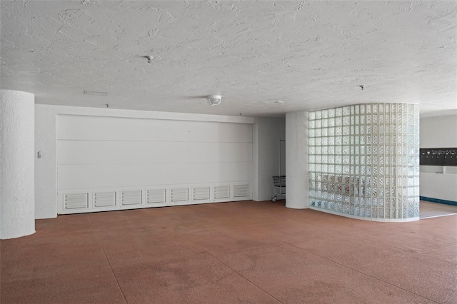 spare room with concrete floors and a textured ceiling