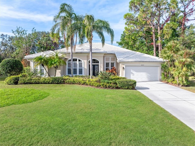 view of front of property featuring a garage and a front yard