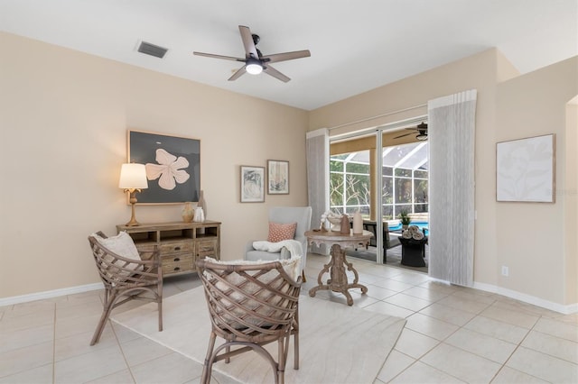 sitting room featuring light tile patterned floors and ceiling fan