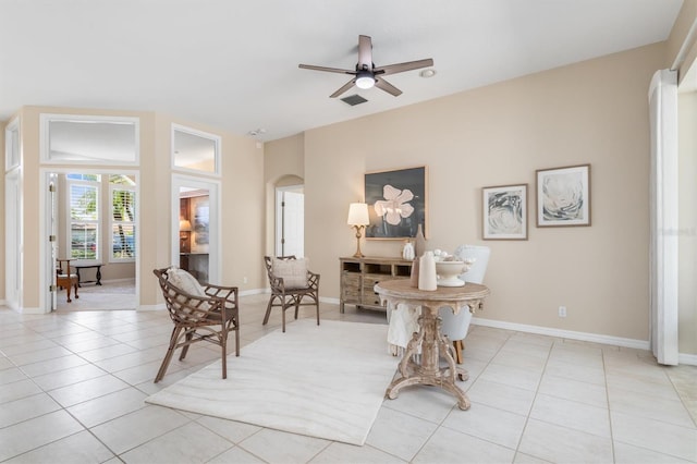 living area featuring light tile patterned flooring and ceiling fan